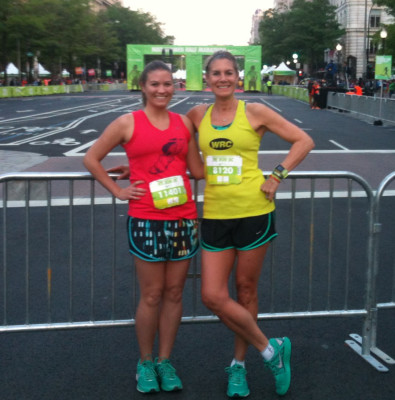 Carla Freyvogel poses with her daughter, Grace Eginton, in their respective club singlets and matching teal sneakers, in front to the NWHM Start/Finish line, at 10th and Pennsylvania Ave, NW. Photo courtesy of W.T.F.