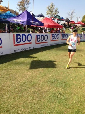 Dan Yi sealing his 79th overall, ﬁrst American and silver medalist ﬁnish at the 2013 Comrades Marathon.