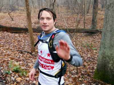 Paul Karlsen, bearing his club colors and displaying impeccable trail etiquette. At the Riffle Ford Rd. Aid Station along the Seneca Creek Greenway Trail, at mile 12.8 of the 2013 Stone Mill 50 Mile Run.