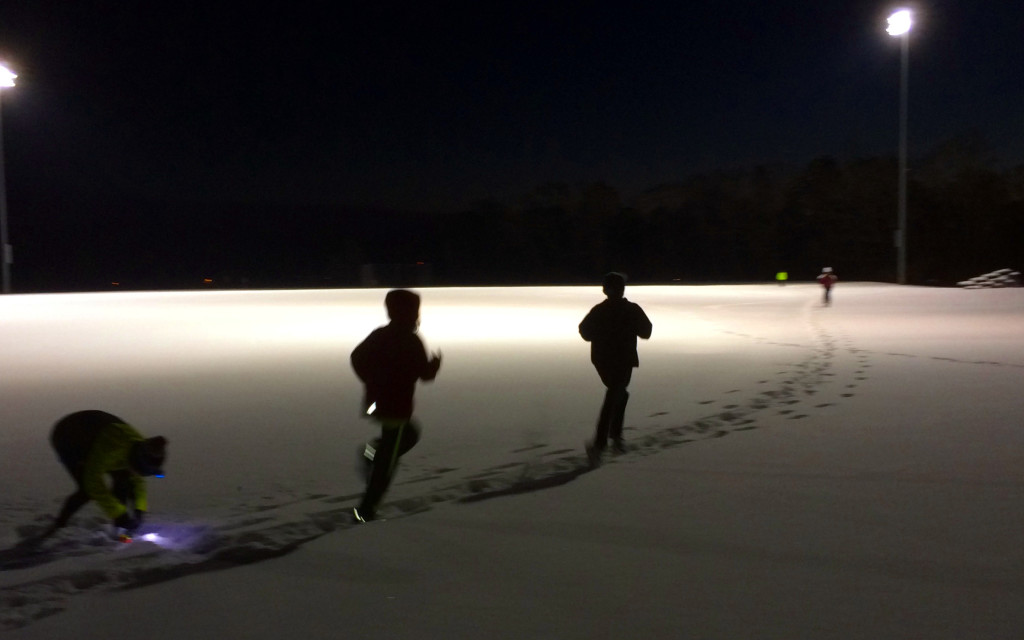 Ten little kids run laps in six inches of snow and 15°F, 5:30 PM on Wednesday, January 29th, under the lights at the Falmouth High School Track. Photo by Ken Gartner